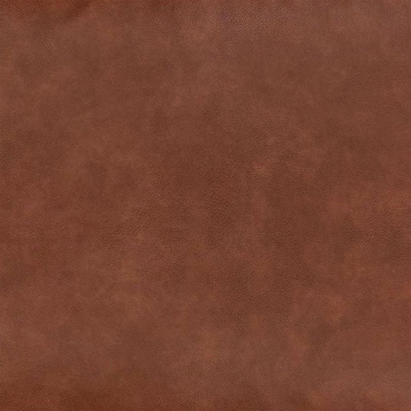 Eine Stoffprobe von der Manufaktur für Hunde. Das Stoffmuster hat die Farbe Kunstleder Cognac